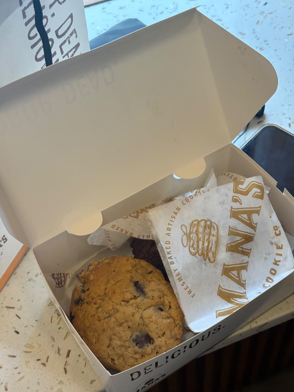Mana’s chocolate-chip cookie in its branded takeaway box